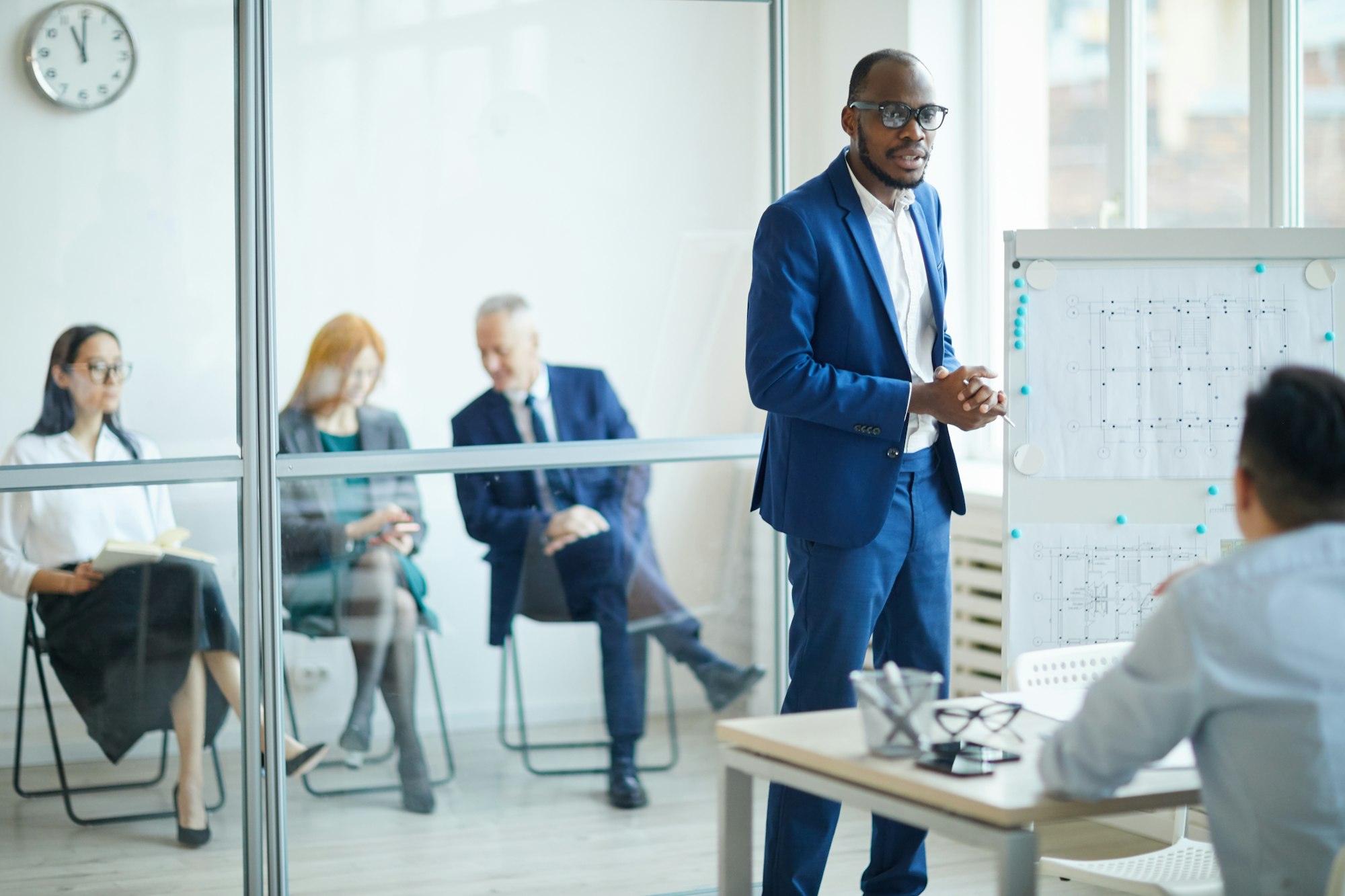 African Man Pitching Ideas to Management