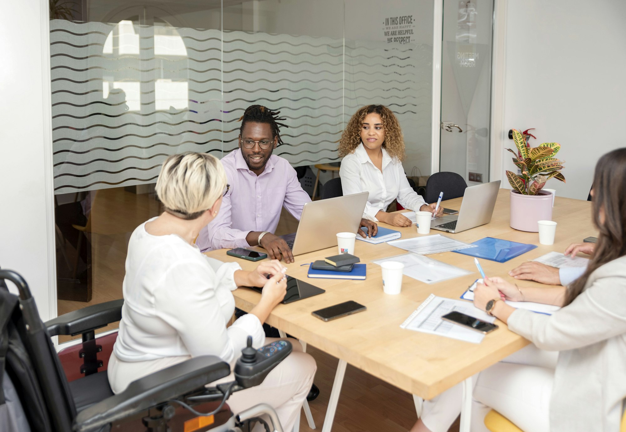 woman in wheelchair participates in office meeting